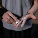 Close-Up View of a Person Putting Talc in His Hands